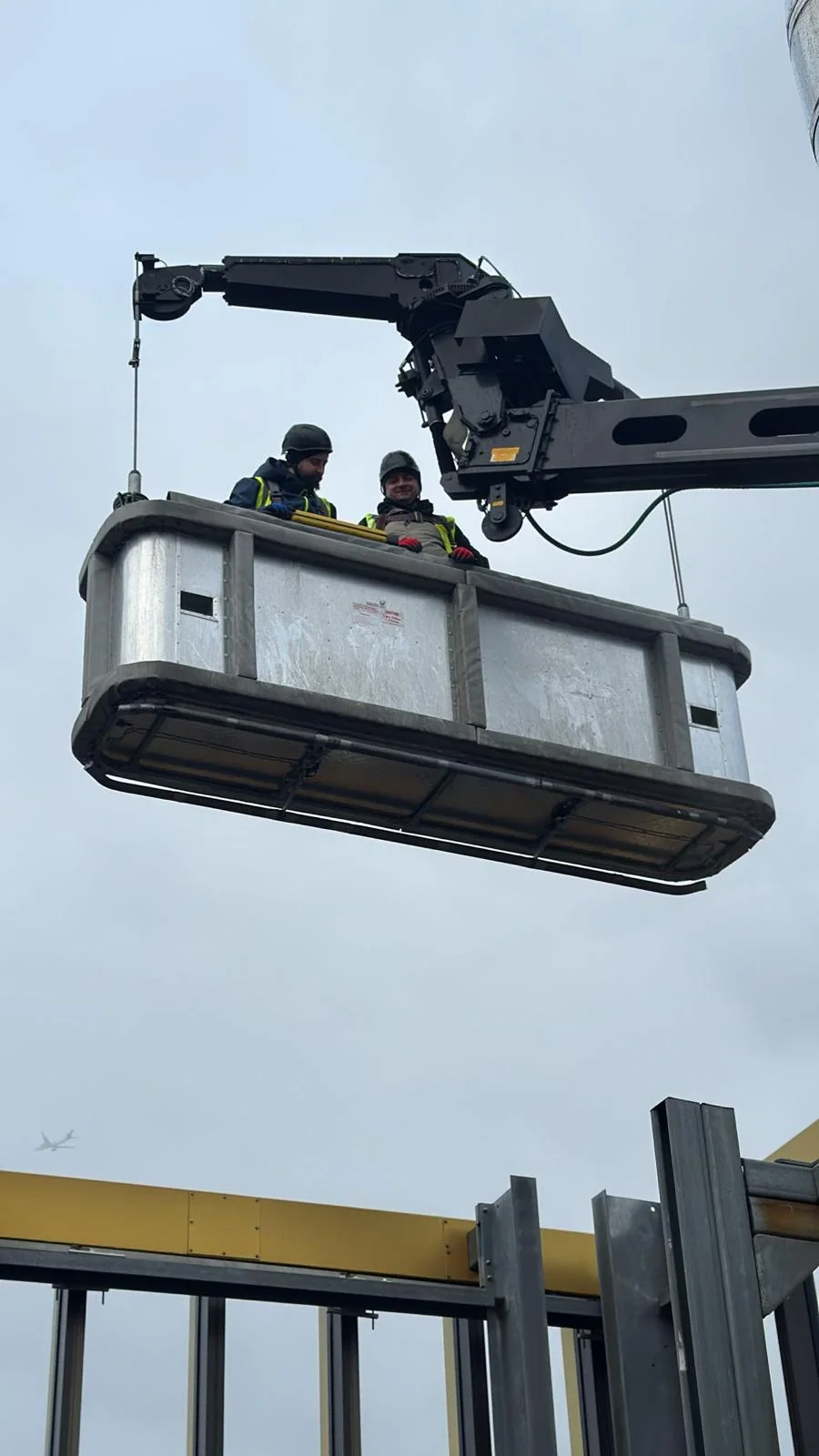 Facade Maintenance technicians working from a suspended building maintenance cradle